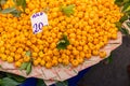 Closeup shot of a pile of fresh oranges put on the floor on a piece of fabric in a public market Royalty Free Stock Photo