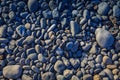 Closeup shot of a pile of gray rocks and pebbles on a seashore