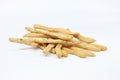 Closeup shot of a pile of homemade breadsticks isolated on a white surface