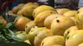 Closeup shot of a pile of mangoes at a market