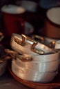 Closeup shot of a pile of metal pots on a shelf