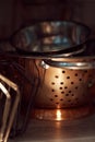 Closeup shot of a pile of metal pots on a shelf