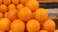 Closeup shot of a pile of oranges at a market