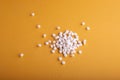 Closeup shot of pile of pills isolated on an orange background