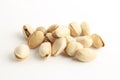 Closeup shot of a pile of pistachios on a white surface