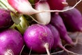 Closeup shot of a pile of purple radishes isolated on the table