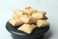 Closeup shot of a pile of square puff biscuits on a black pastry stand