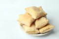 Closeup shot of a pile of square puff biscuits on a plate