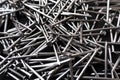 Closeup shot of a pile of steel nails on a black background