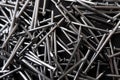 Closeup shot of a pile of steel nails on a black surface