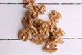 Closeup shot of a pile of walnuts on a wooden surface