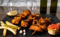 Closeup shot of Pincho Moruno with French fries and lemon slice on table