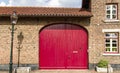 Closeup shot of a pink door on a brown house near a street light during daytime Royalty Free Stock Photo