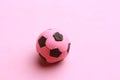 Closeup shot of a pink toy soccer ball isolated on a pink background Royalty Free Stock Photo