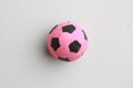 Closeup shot of a pink toy soccer ball isolated on a grey background Royalty Free Stock Photo