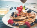 Closeup shot of a plate of delicious pancakes with caramel and berries Royalty Free Stock Photo