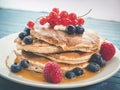 Closeup shot of a plate of delicious pancakes with caramel and berries Royalty Free Stock Photo