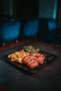 Closeup shot of a plate with grilled meat, potatoes, and vegetables Royalty Free Stock Photo