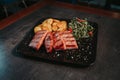 Closeup shot of a plate with grilled meat, potatoes, and vegetables Royalty Free Stock Photo