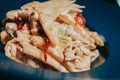 Closeup shot of a plate of macaroni with shredded cheese on top