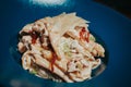 Closeup shot of a plate of macaroni with shredded cheese on top