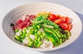 Closeup shot of a poke bowl with tuna, rice and vegetables