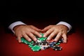 Closeup shot of a poker player taking a big pile of poker chips