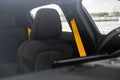 Closeup shot of Polestar 2's driver's seat with a golden seatbelt