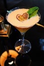 Closeup shot of a Porn star martini cocktail with a passion fruit and a mint leaf on top