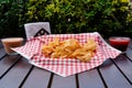 Closeup shot of potato chips and souces on wooden table Royalty Free Stock Photo