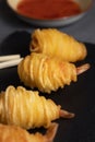 Closeup shot of potato string shrimps on a black board