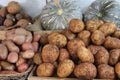Closeup shot of potatoes and squash displayed in a market place Royalty Free Stock Photo