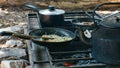 Closeup shot of pots and pans cooking on an outdoor grill