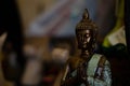 Closeup shot of a praying bronze Buddha statue with eyes closed