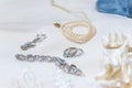 Closeup shot of precious accessories with diamond rings and bracelet and a pearl necklace Royalty Free Stock Photo