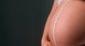Closeup shot of a pregnant woman measuring her belly Royalty Free Stock Photo