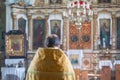 Closeup shot of a priest praying at church