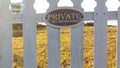 Closeup shot - Private No Tresspassing sign on picket fence