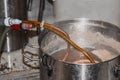 Closeup shot of the process of brewing fresh beer in a metallic container