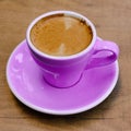 Closeup shot of a purple cup of coffee on blurred background Royalty Free Stock Photo