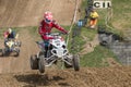 Closeup shot of quad rider in red jumping Royalty Free Stock Photo