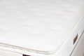 Closeup shot of a quilted white mattress and topper with soft flowers pattern Royalty Free Stock Photo