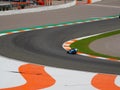 Closeup shot of a racing track with a motorcyclist