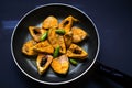 Closeup shot of raw uncooked marinated pieces of fish in a pan