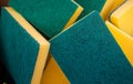 Closeup shot of rectangular yellow sponges with green abrasive sides