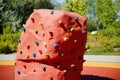 Closeup shot of a red artificial boulder in a playground