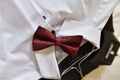 Closeup shot of a red bow tie on a white shirt under the lights - fashion concept Royalty Free Stock Photo