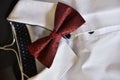 Closeup shot of a red bow tie on a white shirt under the lights - fashion concept Royalty Free Stock Photo