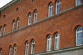 Closeup shot of a red brick building with arched windows Royalty Free Stock Photo