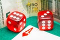 Closeup shot of red dices, playing cards and money on a poker table Royalty Free Stock Photo